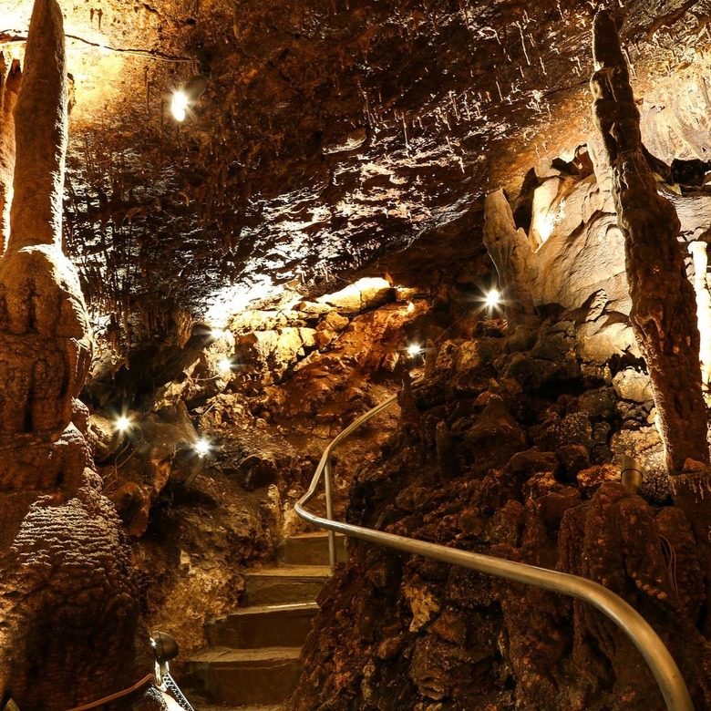 Interior of a cavern illuminated by lights on the stairs.