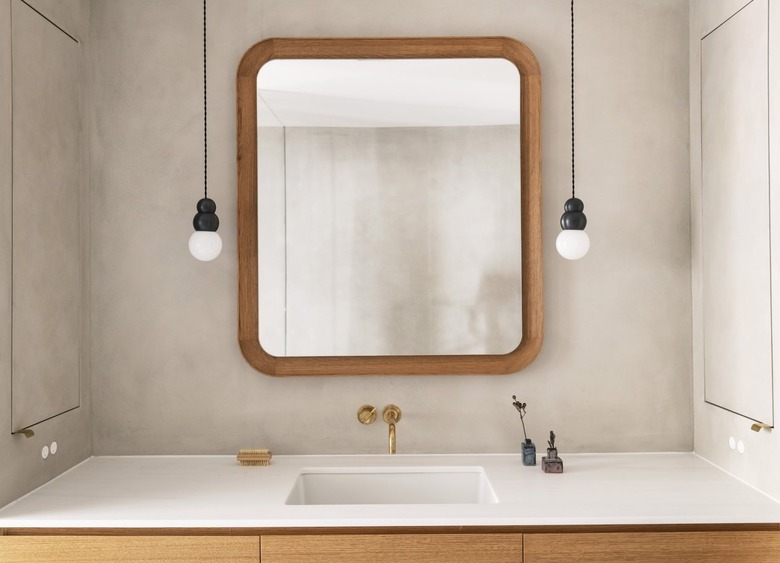 muted bathroom with mini sculptural pendant lights