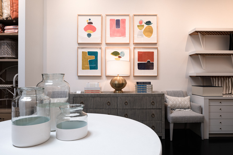 vases near a wall with artworks