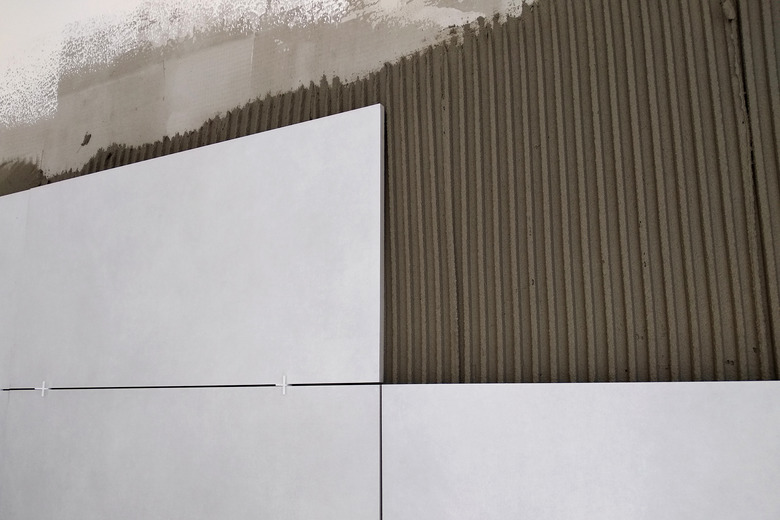 Wall ceramic tiles installation on mortar glue.