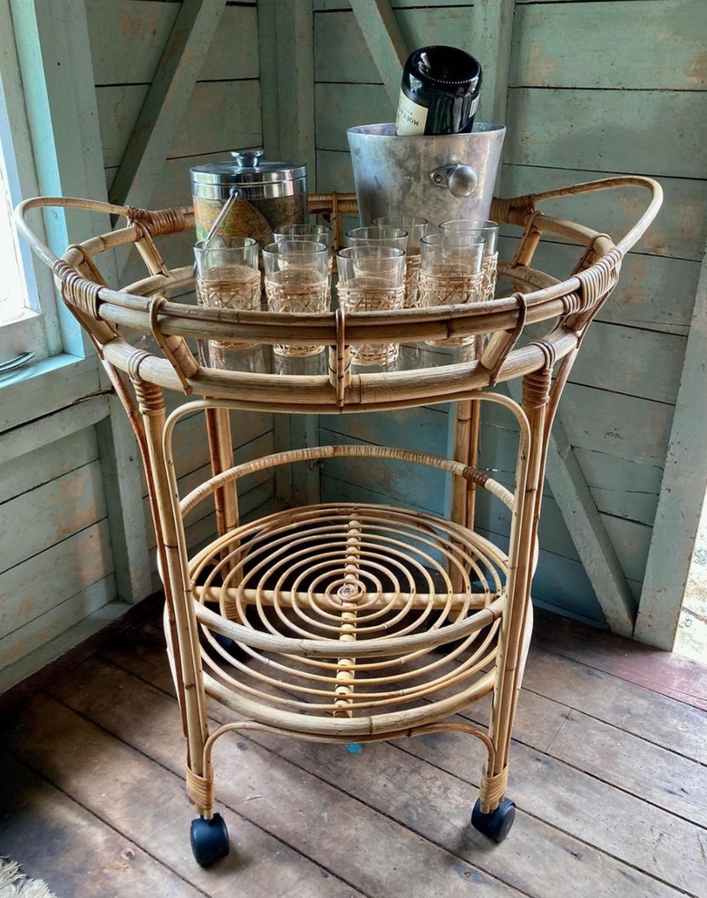 Bamboo circular bar cart with glassware.