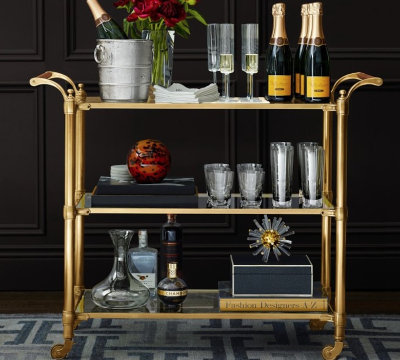 Brass finish bar cart with glassware