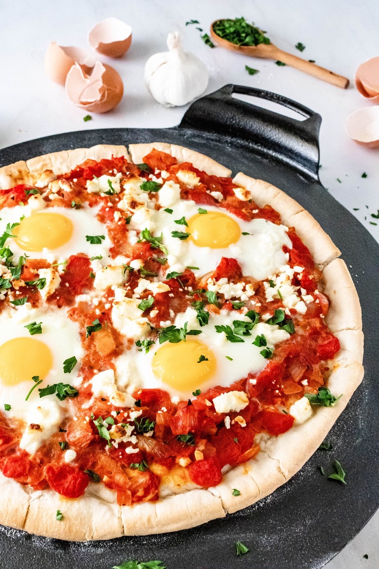 Shakshuka pizza on a black cast iron dish