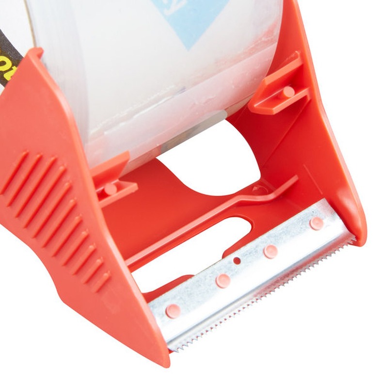 Close up of the red tab on a shipping tape dispenser.