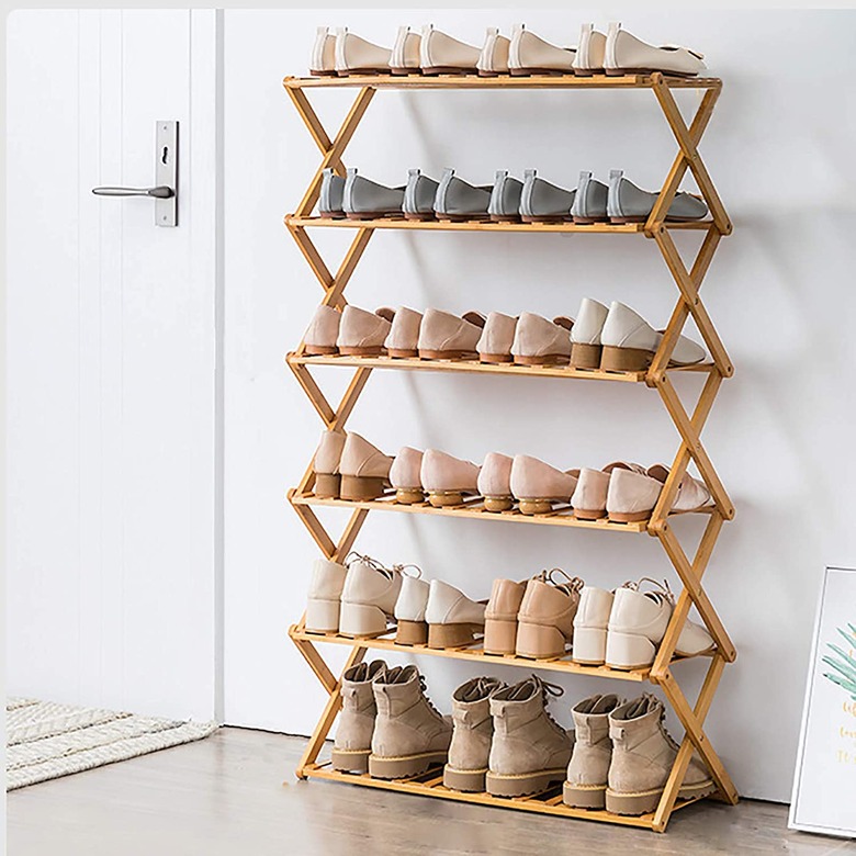 Wood folding shoe organizer by front door.