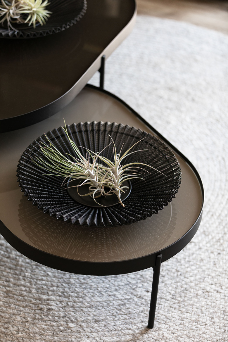black fruit bowl designed by Gubi on coffee table