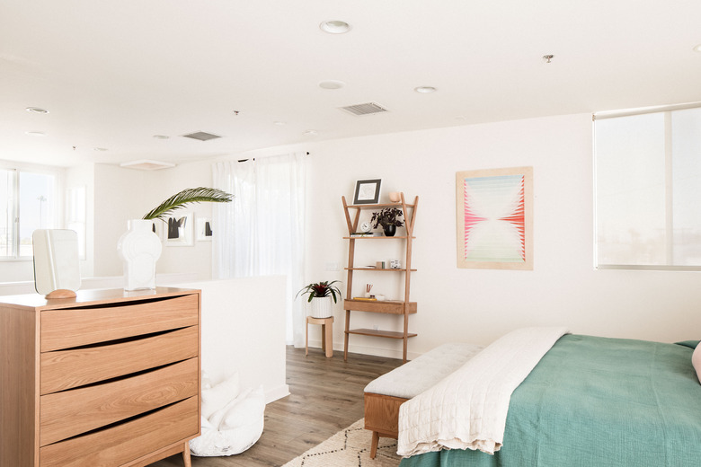 four drawer dresser in bedroom with bed bench and shelving unit