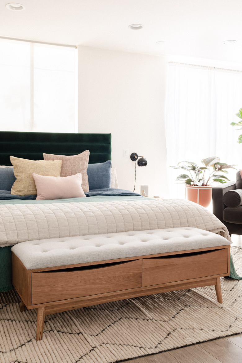 bed bench in front of bed with tufted seat and two drawers for storage