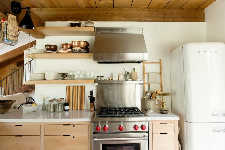 A kitchen with a retro white fridge