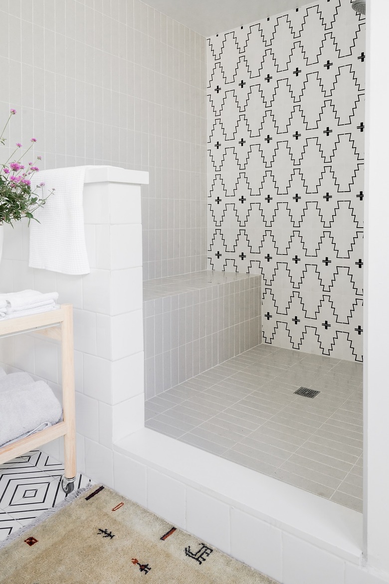 gray, black, and white bathroom with ledge shower storage ideas