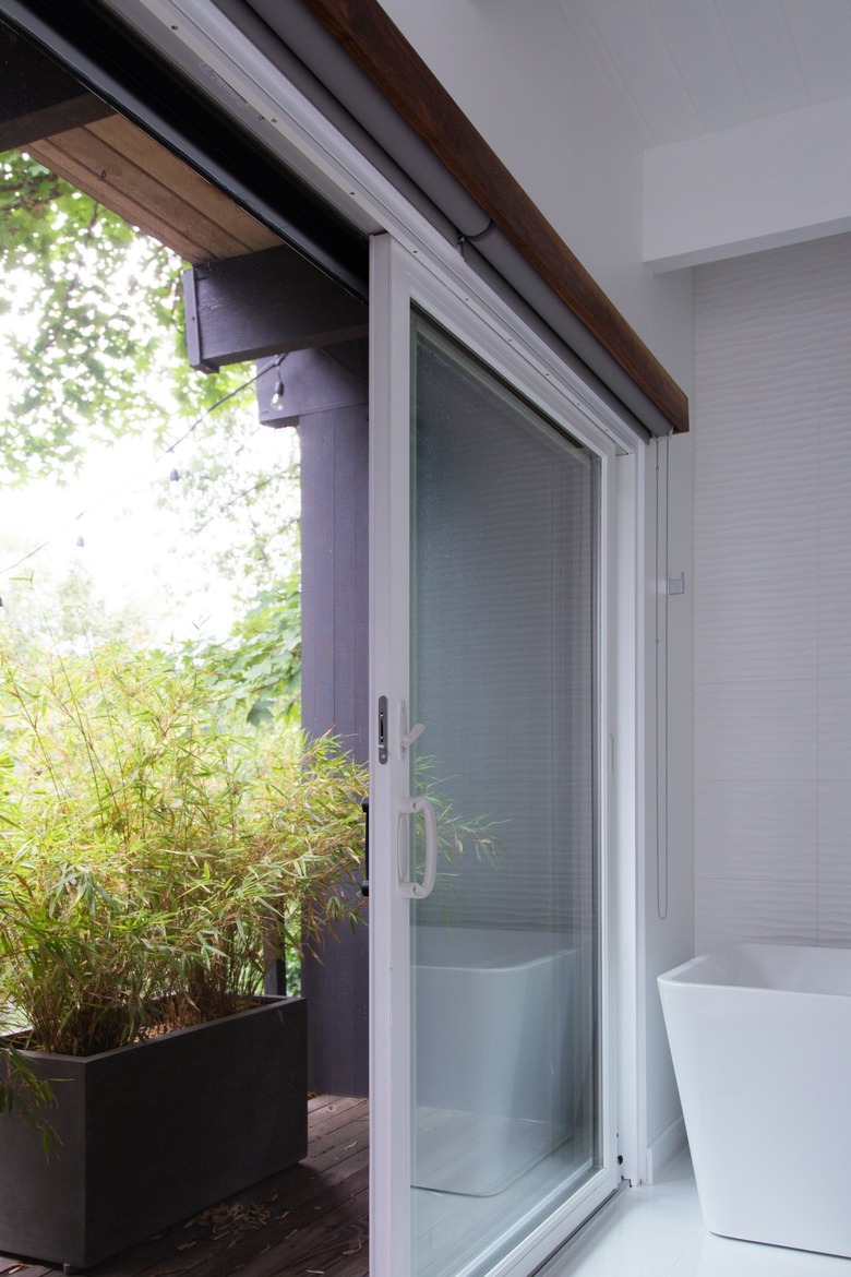 Sliding doors and a plant in a wood box.