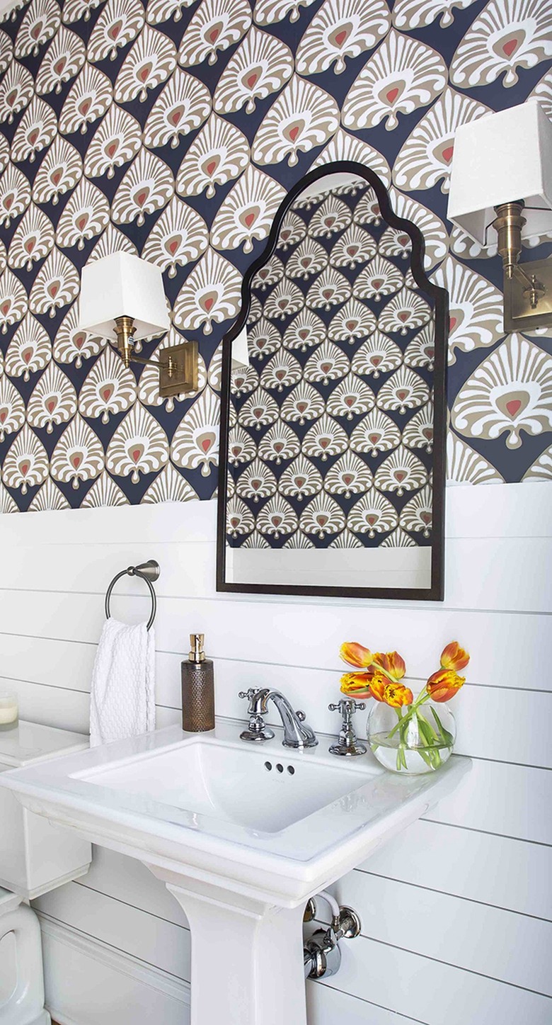 Boho bathroom with white shiplap along the bottom of the wall and an Indian print wallpaper along the top half