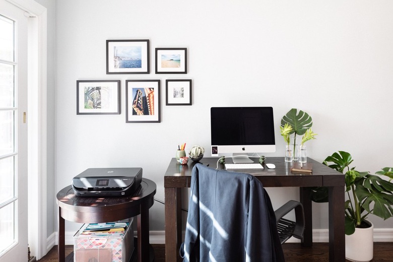 Modern minimalist small home office idea with small gallery wall and wood desk