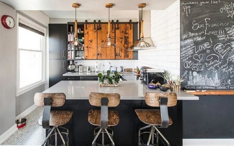 Small industrial kitchen with wooden bar stools