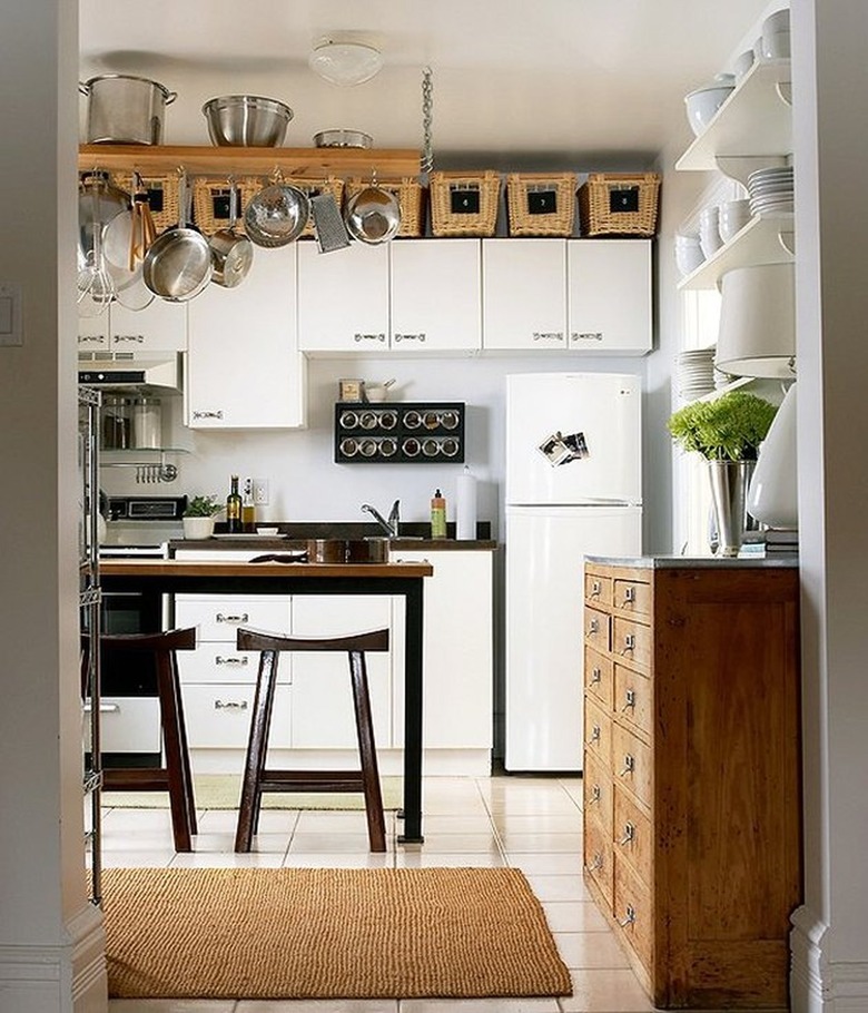 White kitchen with storage above the cabinets by One Kings Lane