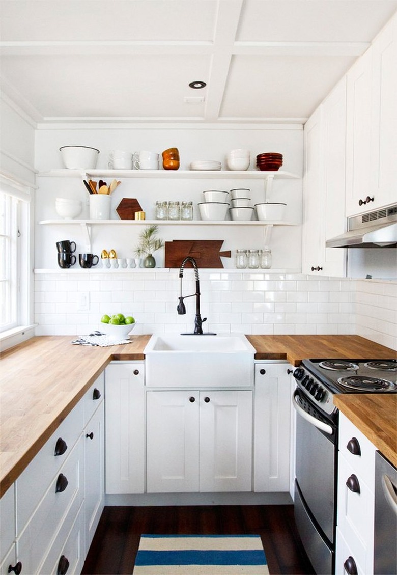 White kitchen with open shelves designed by Sarah Sherman Samuel