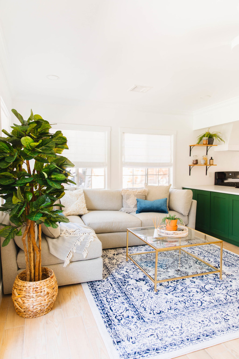 Modern small living room decorating idea with green cabinet and small sectional sofa