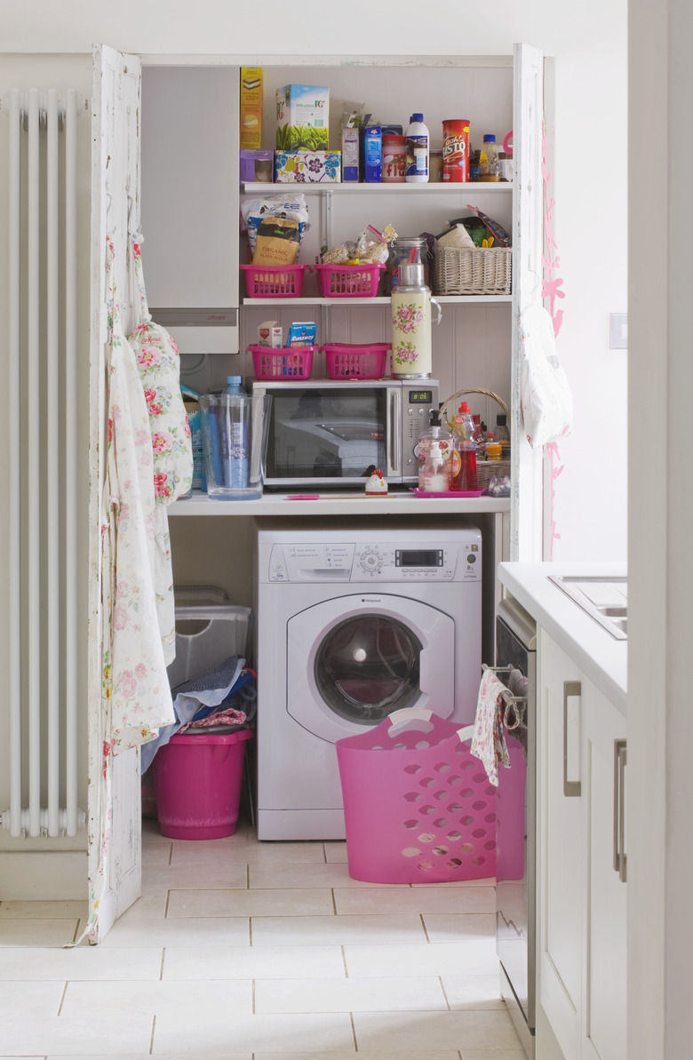 Galley kitchen with clothes washer.