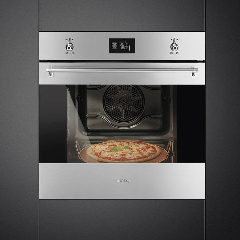 Stainless steel wall oven in black cabinets. Small Stove and Oven