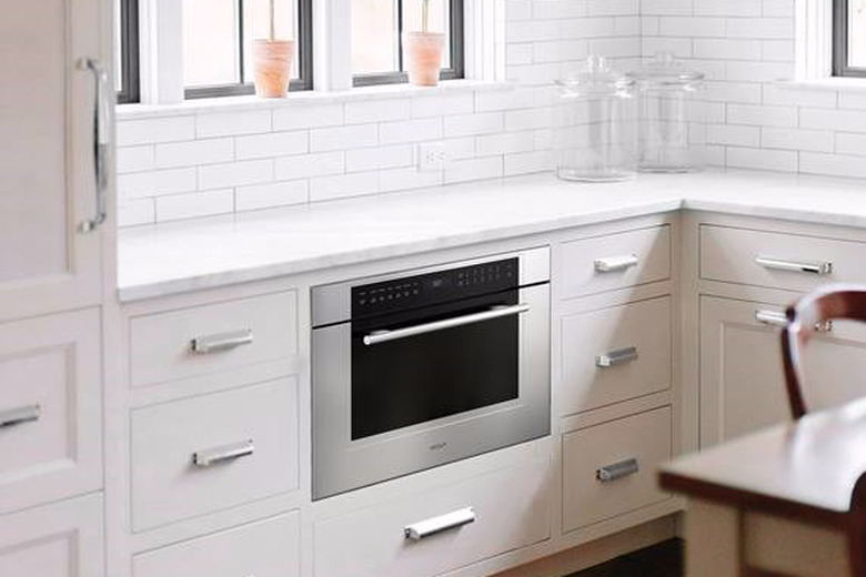 Wall oven under counter in white kitchen. Small Stove and Oven