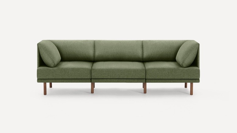 Green sofa with wooden accents