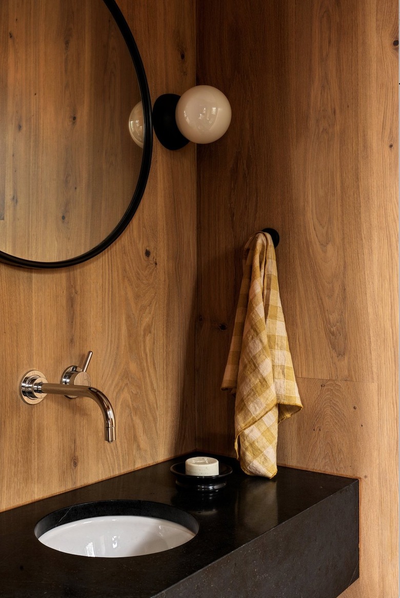 powder room with wood-clad walls