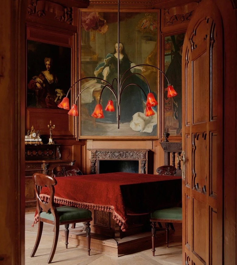 Black and red floral chandelier over a table with a red tablecloth