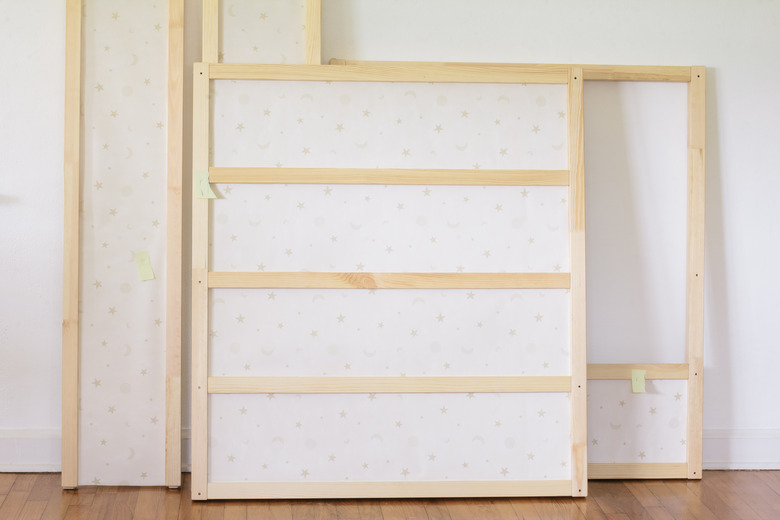 KURA bed panels covered in wallpaper