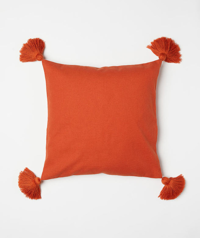 orange accent pillow with fringe tassels from H&M