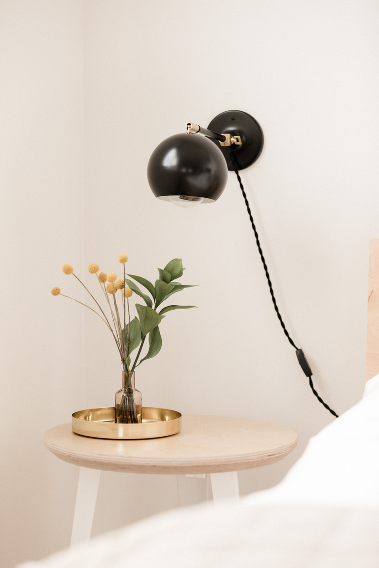 Bedside table with wall sconce