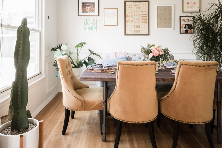 Dining room with plants and artwork on wall