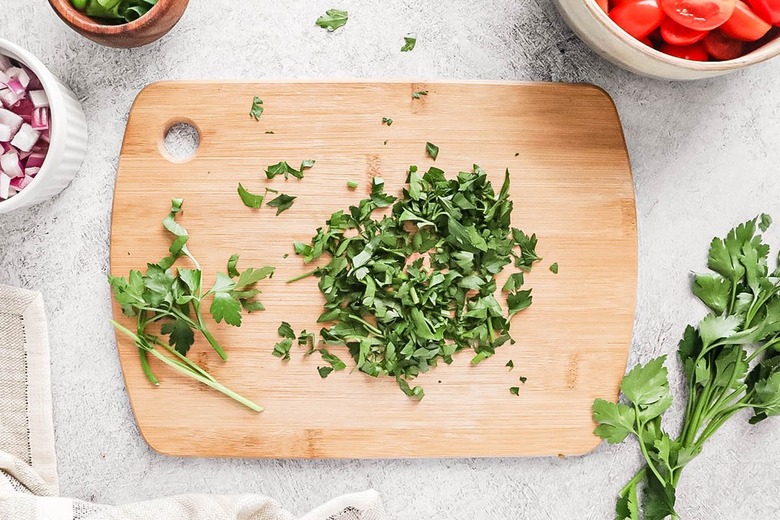 Chopped fresh parsley on a wooden cutting board