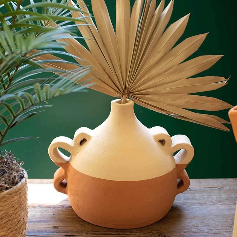 A Jungalow vase featured wavy handles on both sides. The bottom of the vase is a terra cotta color