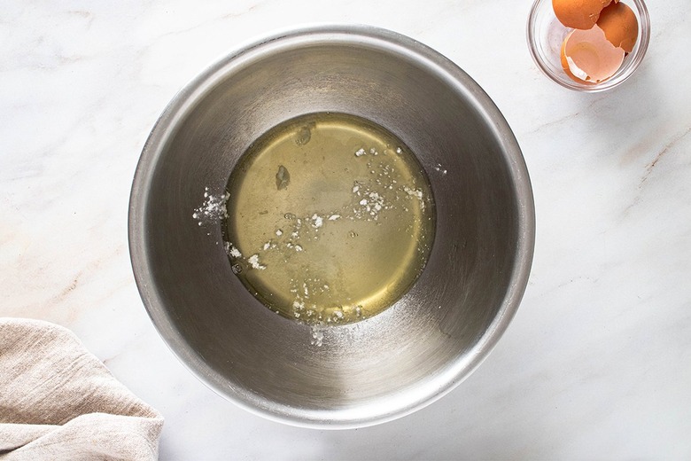 Egg whites and cream of tartar in a stainless steel bowl