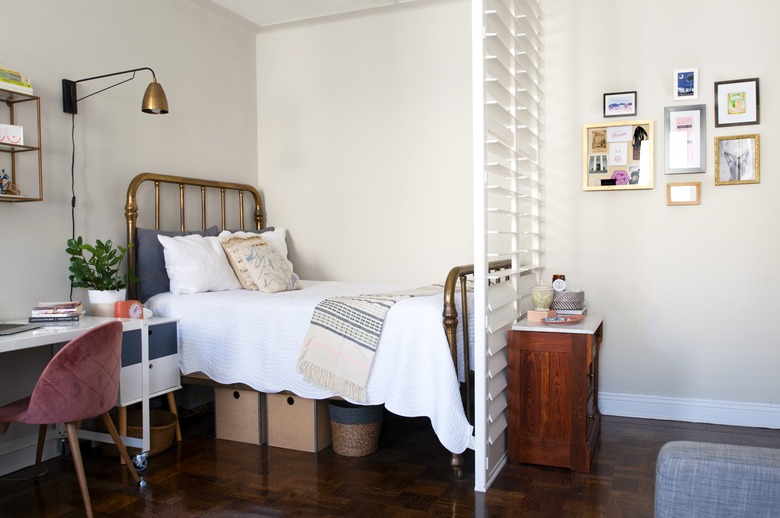 Bed with brass headboard and shutters