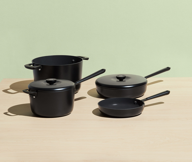 Black ceramic cookware set shown on green background