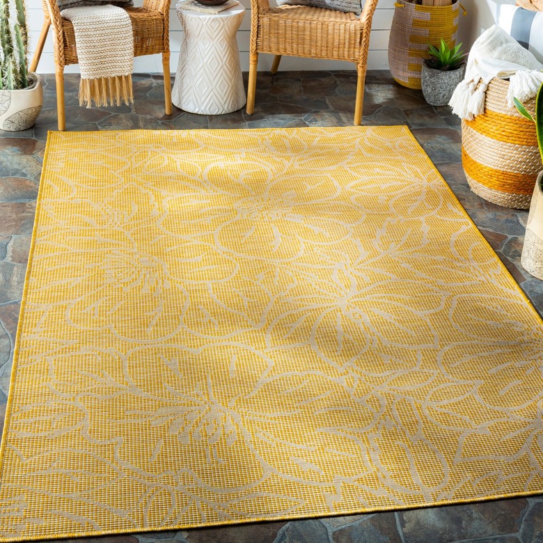 bright yellow area rug with white flower designs