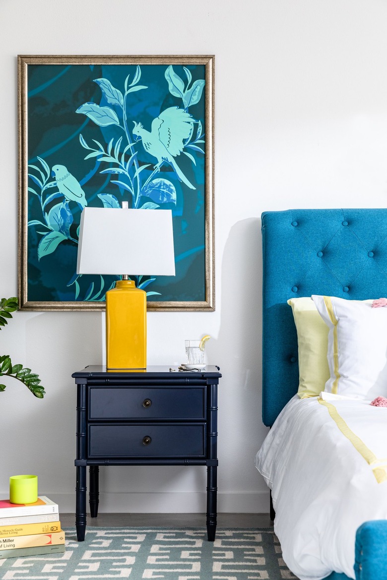 white bedroom with colorful bed and bedding