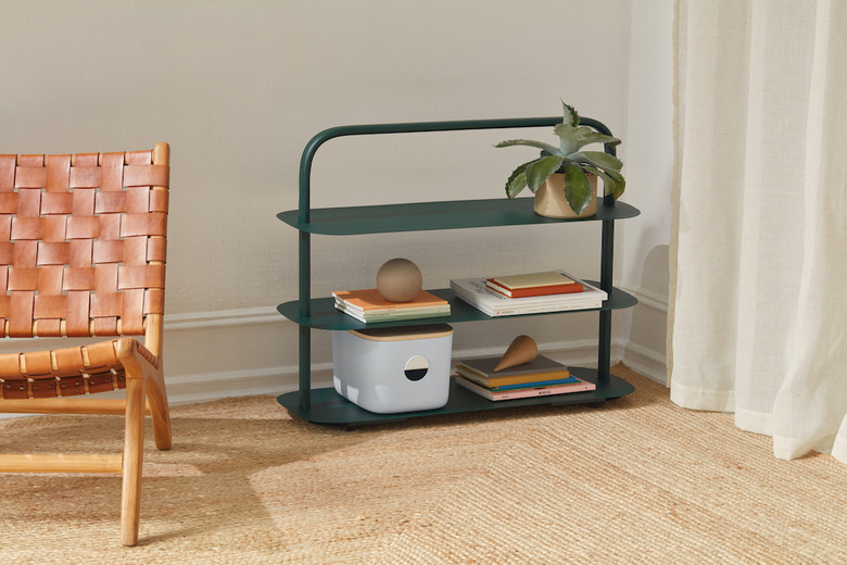 sustainable home decor with green tiered rack next to a chair