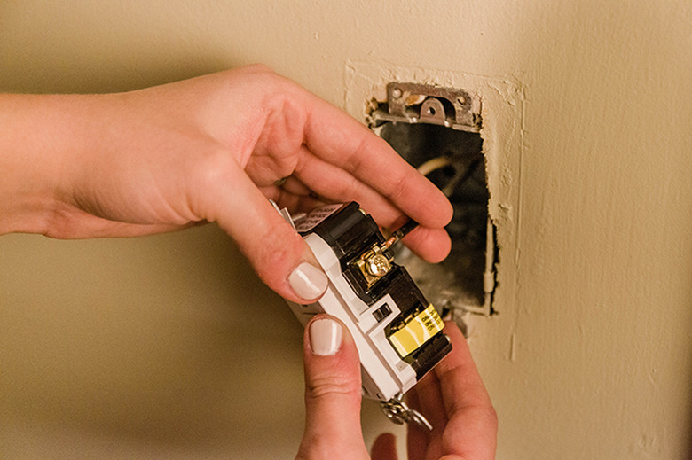 Insert the wire under the screw in the outlet.