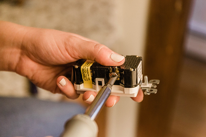 Loosen the screws on your new outlet.