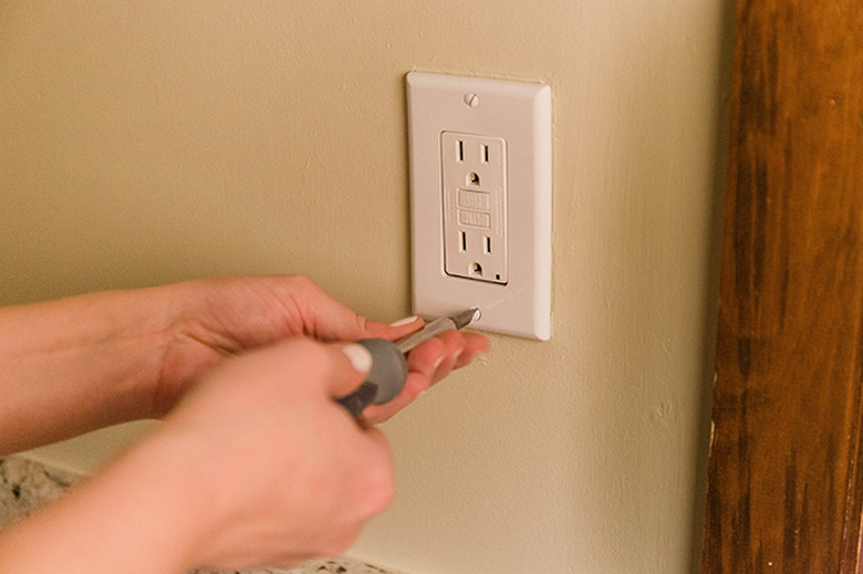 Screw on the outlet cover.