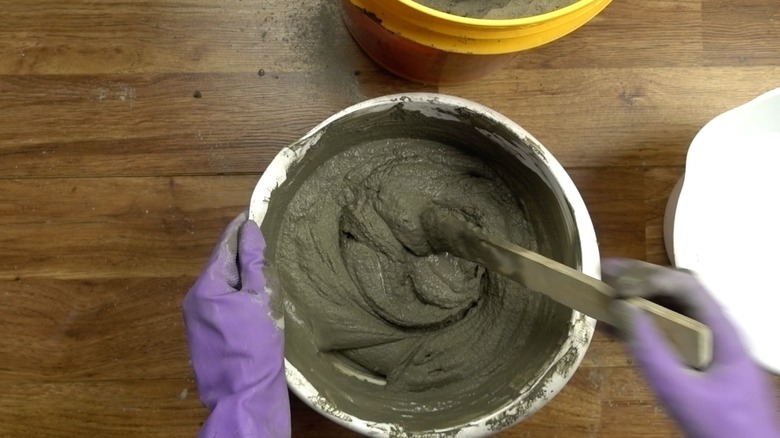 Mixing concrete for DIY tabletop concrete fire bowl.