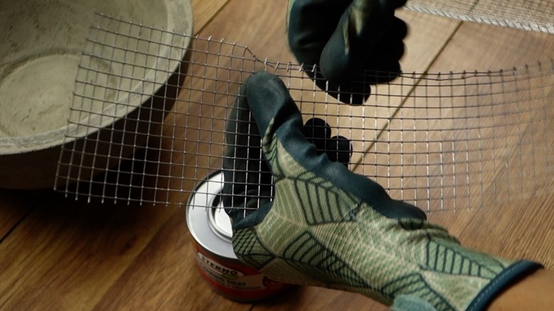 Making a fuel can holder with wire mesh for DIY concrete fire bowl.