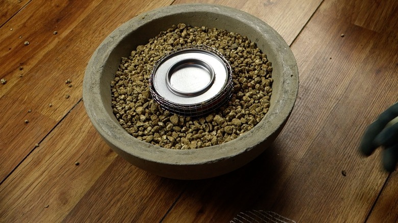 Assembling DIY concrete fire bowl.