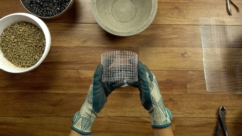 Making a fuel can holder with wire mesh for DIY concrete fire bowl.