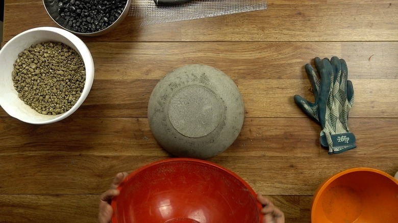 Molding concrete for DIY tabletop concrete fire bowl.