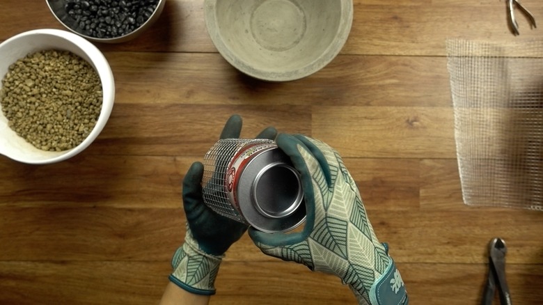 Making a fuel can holder with wire mesh for DIY concrete fire bowl.