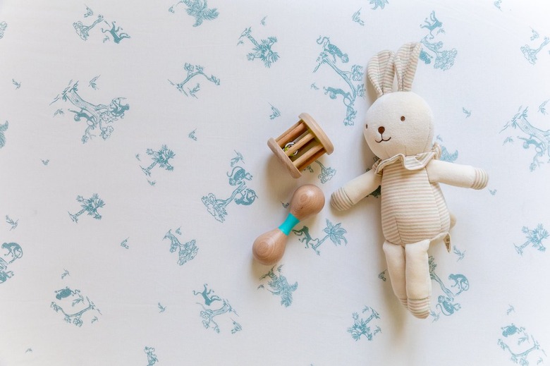 White sheets featuring blue illustrations monkeys playing in trees.