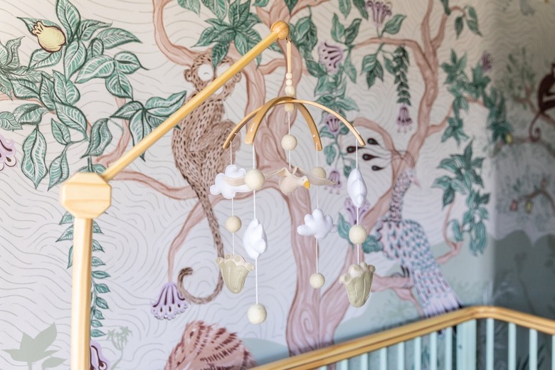 A mobile above a crib featuring felt clouds